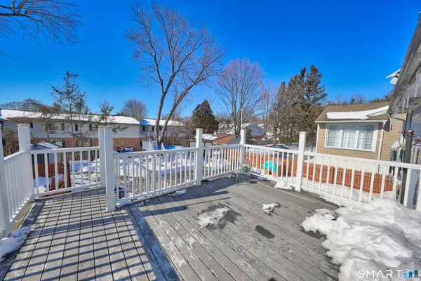 a view of a house with a yard covered in snow