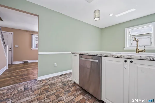 a view of a kitchen with a sink and dishwasher