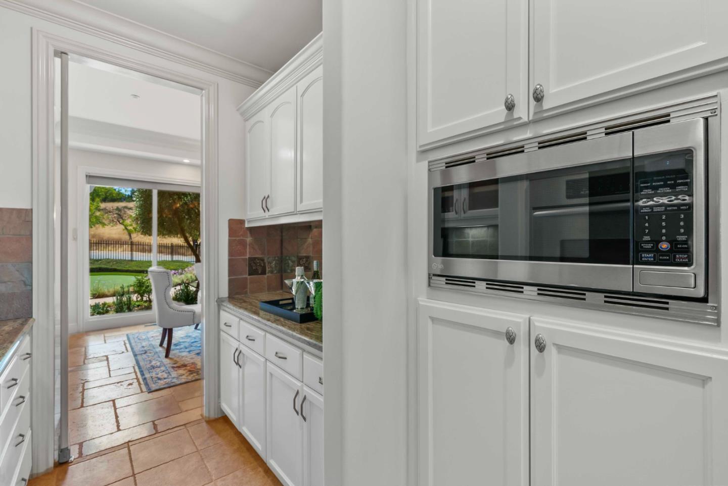 2390 Rockwood Ranch Road Morgan Hill, CA 95037 - Photo 18 of 92 a kitchen with granite countertop white cabinets and stainless steel appliances