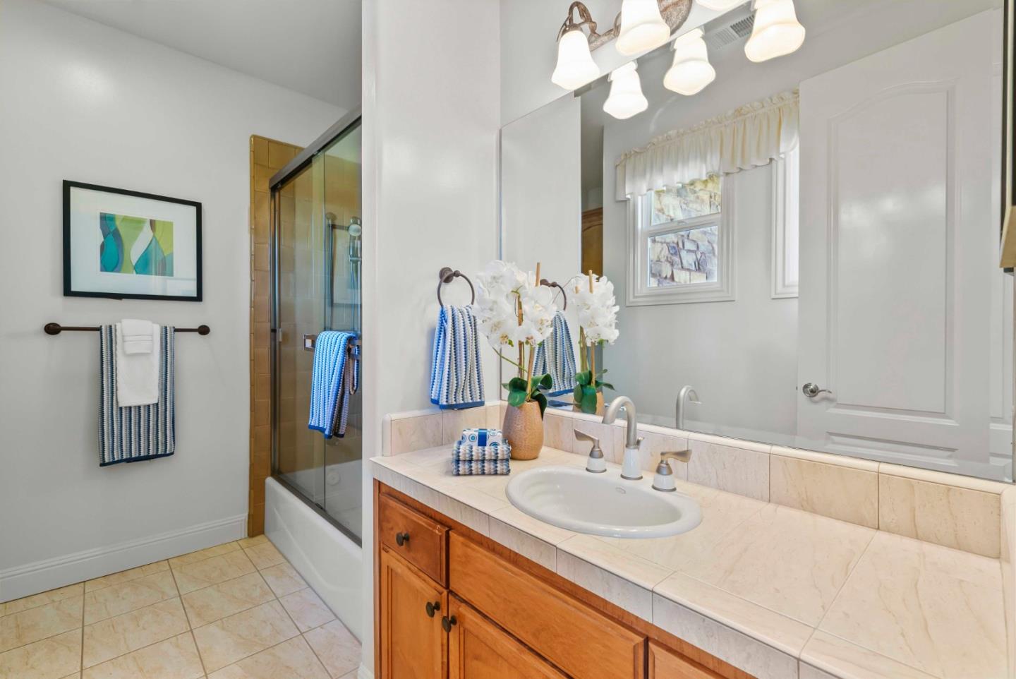 2390 Rockwood Ranch Road Morgan Hill, CA 95037 - Photo 58 of 92 a bathroom with a sink a large mirror and a shower