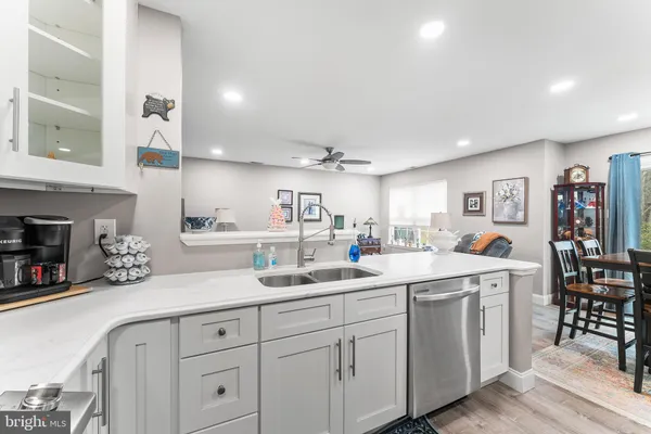a kitchen with white cabinets and white appliances