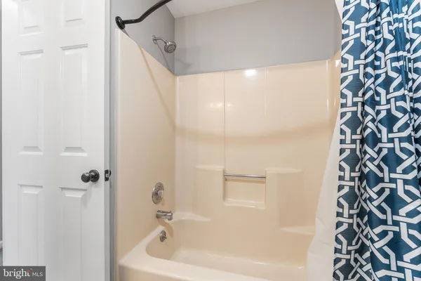 a bathroom with a bathtub and shower