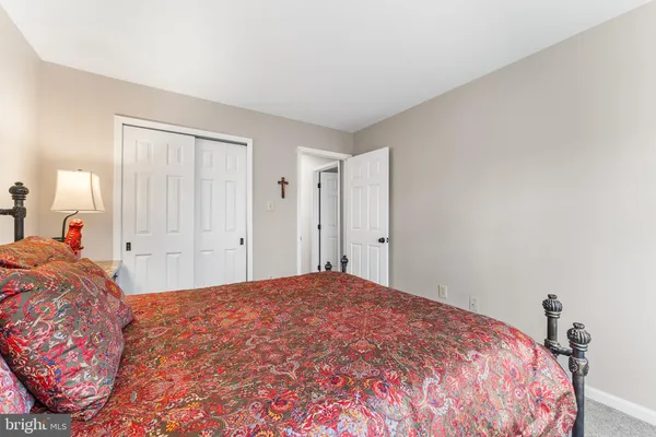 a bedroom with a bed and a closet