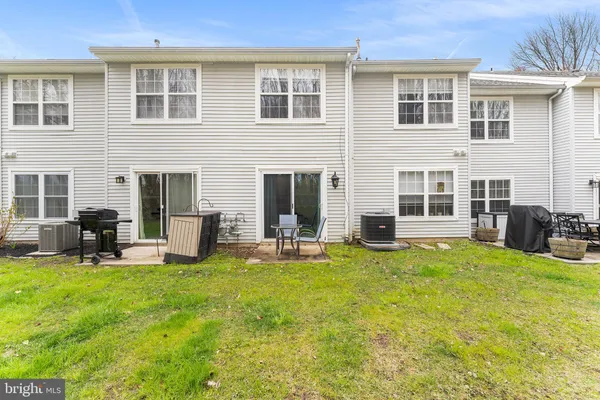 a view of a house with a yard and sitting area