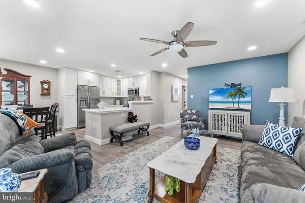 a living room with furniture and kitchen view