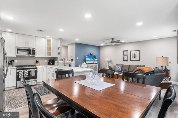 a large kitchen with a table and chairs