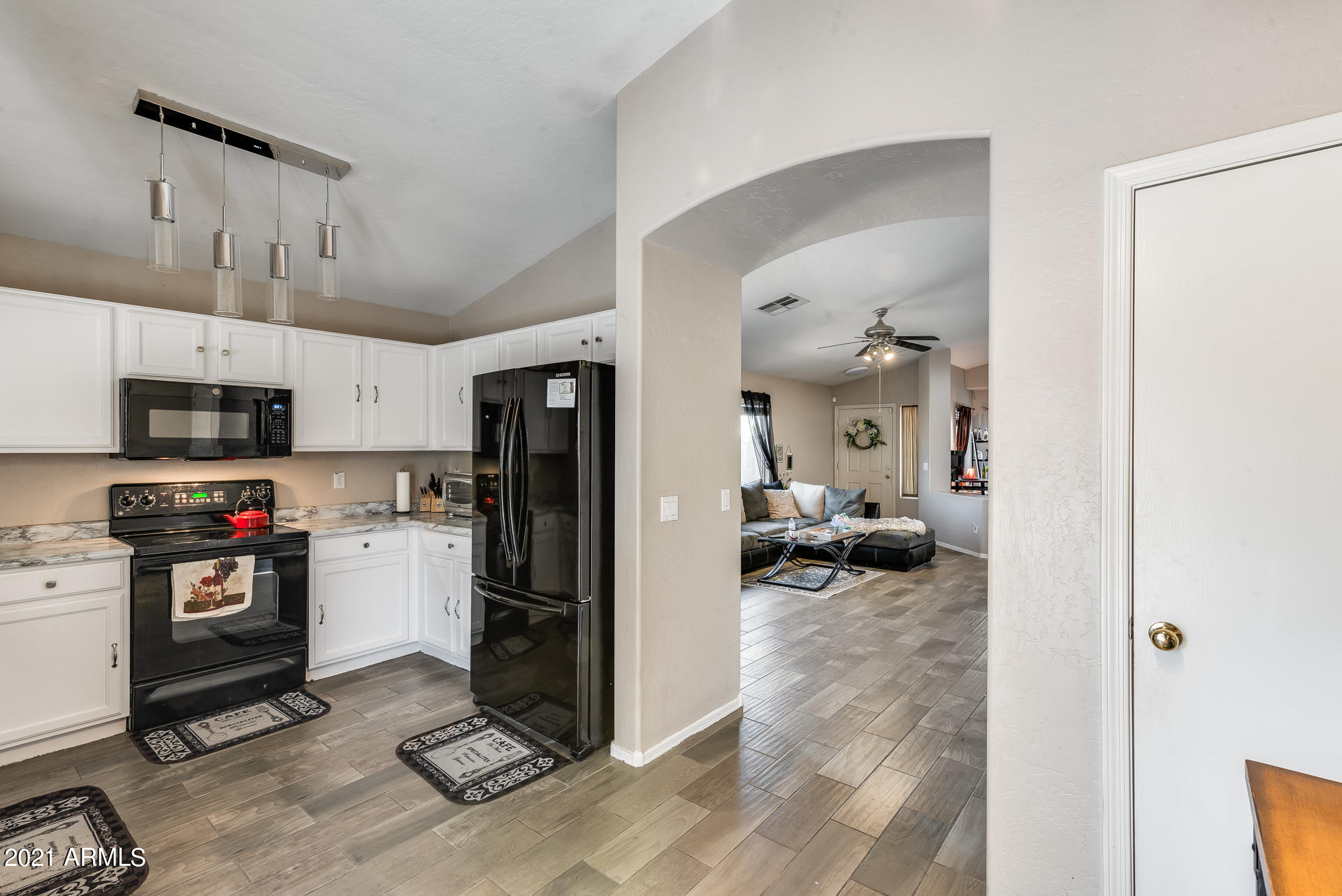 15037 West Calavar Road Surprise, AZ 85379 - Photo 22 of 28 a view of kitchen appliances cabinets and a view of kitchen