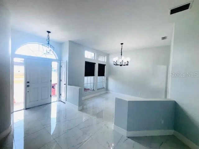 a view of a hallway with chandelier