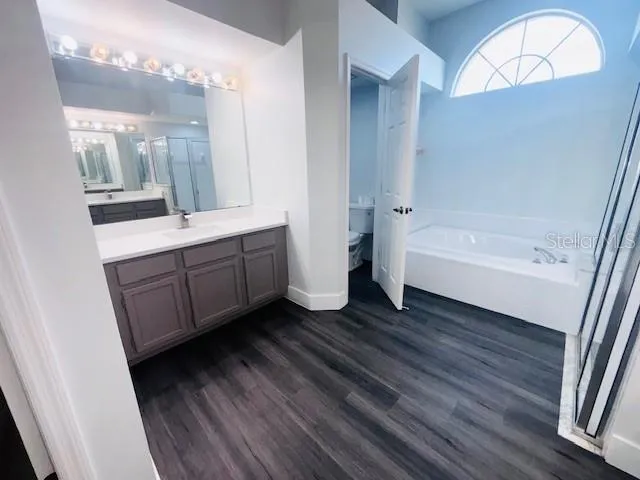 a bathroom with a double vanity sink and a mirror
