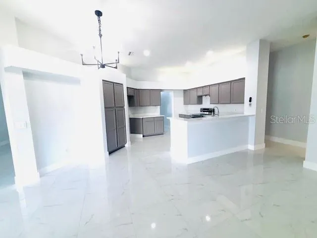 a view of a kitchen with a sink and a refrigerator