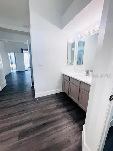 a view hallway with wooden floor and staircase