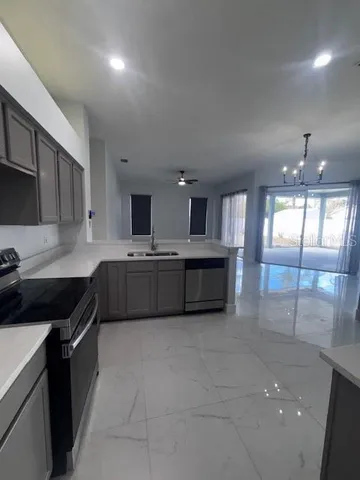 a large kitchen with a sink and cabinets