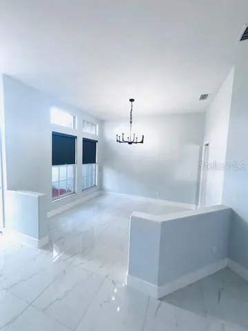 a spacious bathroom with a tub and mirror