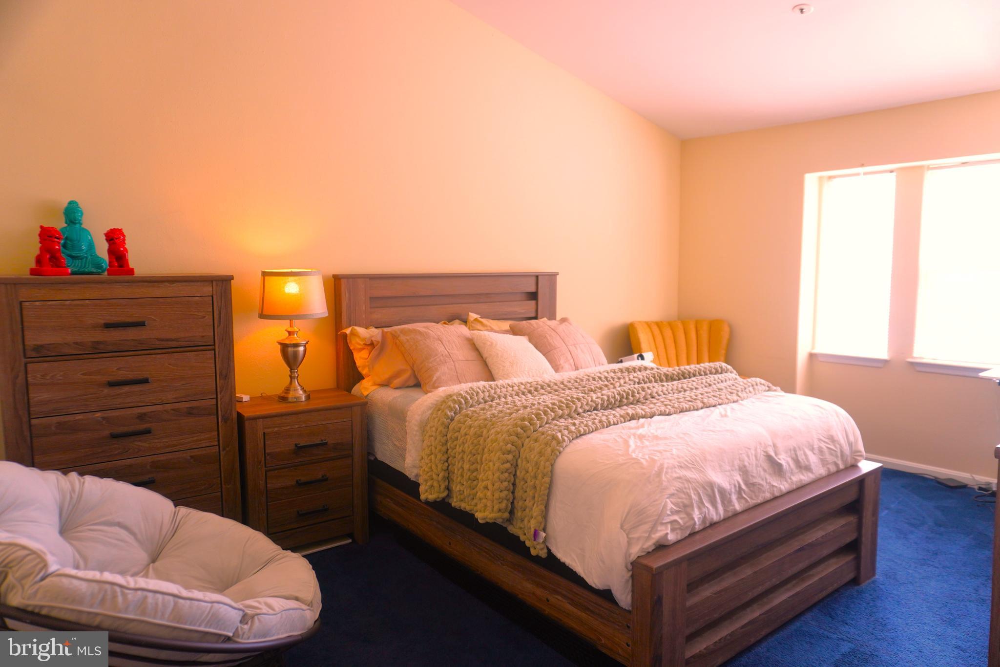 8559 Falls Run Road, Unit L Ellicott City, MD 21043 - Photo 14 of 28 a bedroom with a bed and a couch