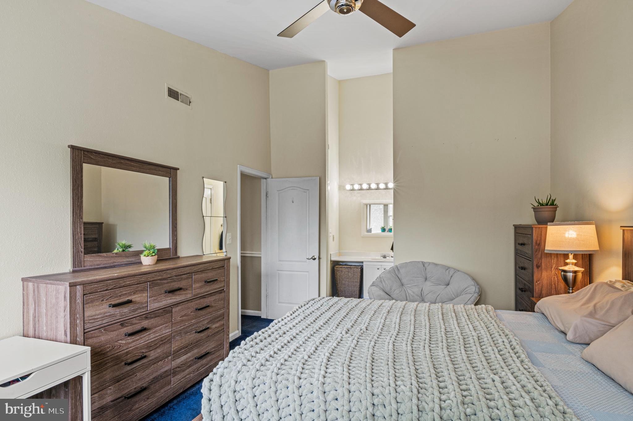 8559 Falls Run Road, Unit L Ellicott City, MD 21043 - Photo 16 of 28 a bedroom with a bed and a dresser