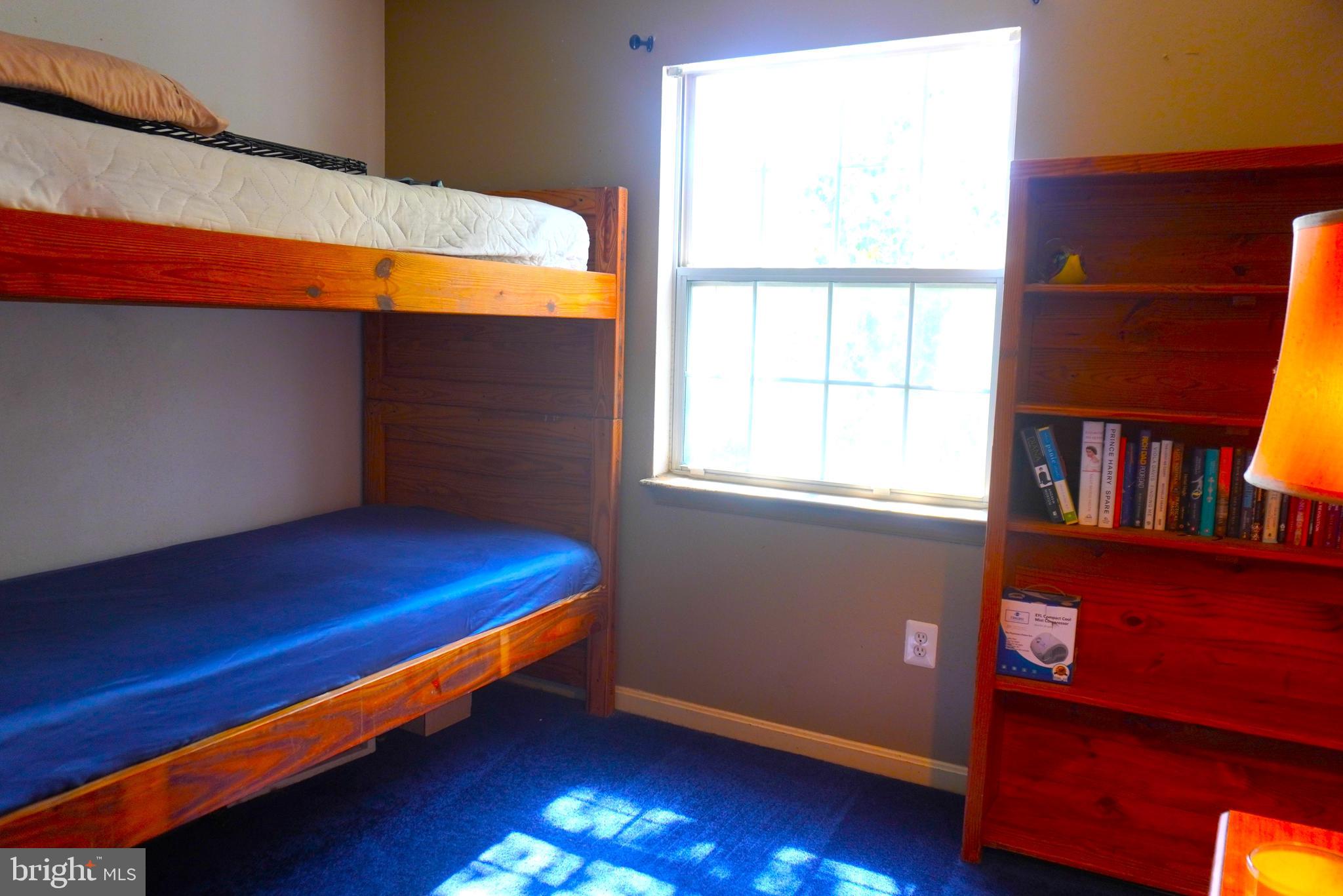 8559 Falls Run Road, Unit L Ellicott City, MD 21043 - Photo 19 of 28 a room with window and a book shelf