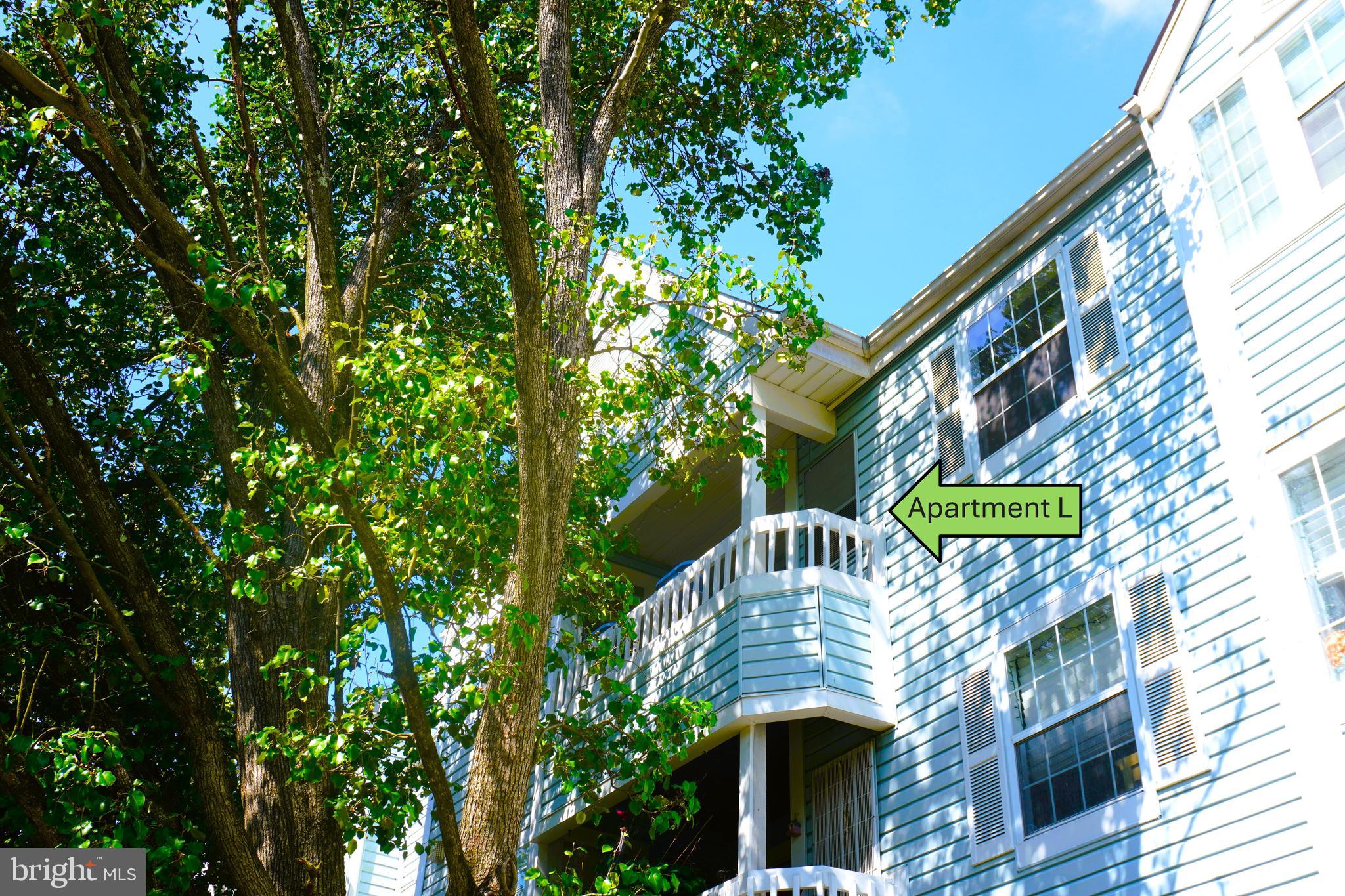8559 Falls Run Road, Unit L Ellicott City, MD 21043 - Photo 2 of 28 a front view of a house with garden