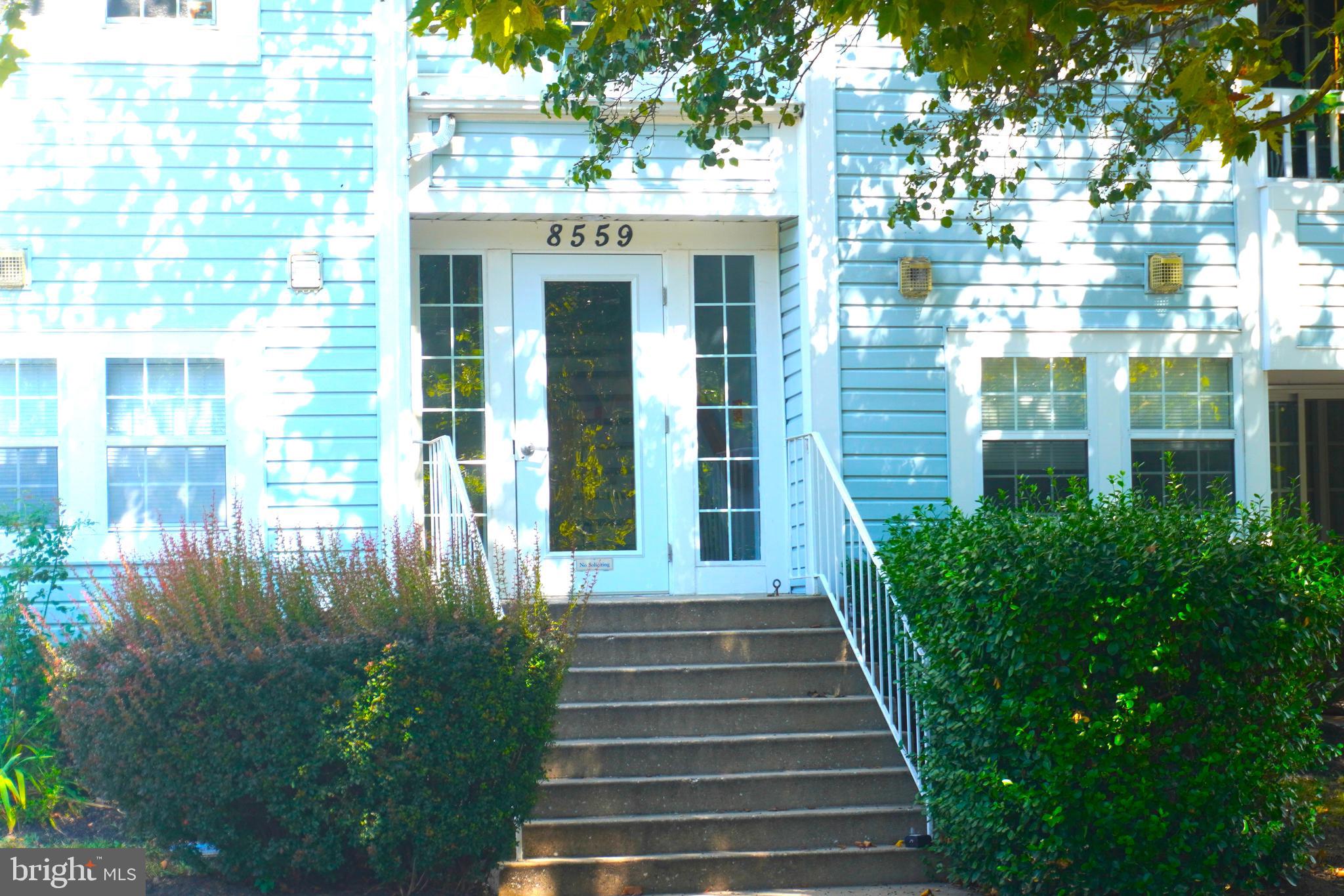 8559 Falls Run Road, Unit L Ellicott City, MD 21043 - Photo 27 of 28 a view of a brick house with a yard