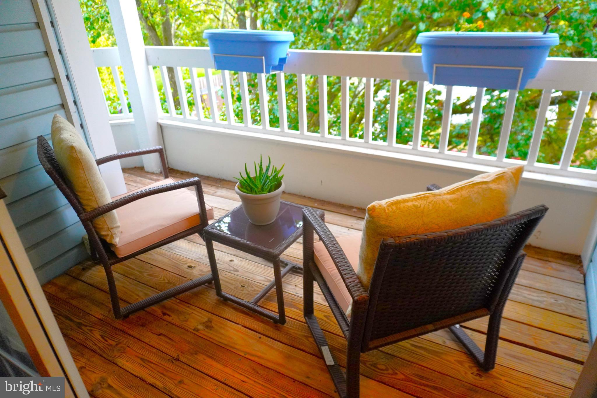 8559 Falls Run Road, Unit L Ellicott City, MD 21043 - Photo 3 of 28 a view of porch with a table and chairs