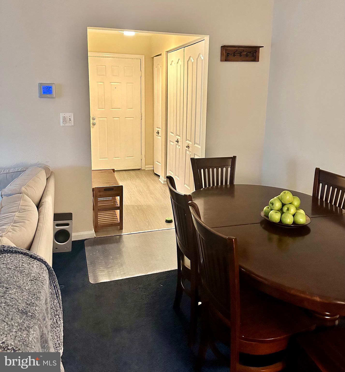8559 Falls Run Road, Unit L Ellicott City, MD 21043 - Photo 4 of 28 a view of a dining room with furniture and wooden floor