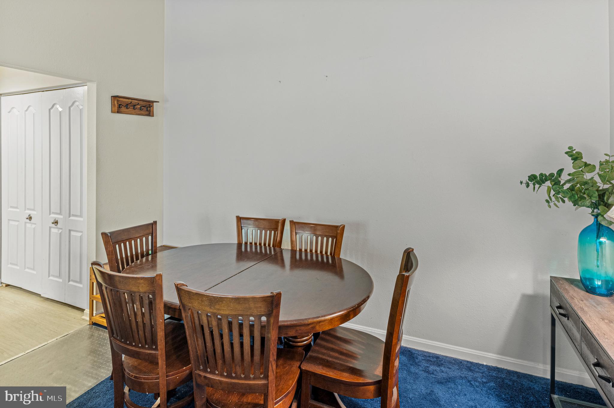 8559 Falls Run Road, Unit L Ellicott City, MD 21043 - Photo 9 of 28 a view of a dining room with furniture and wooden floor