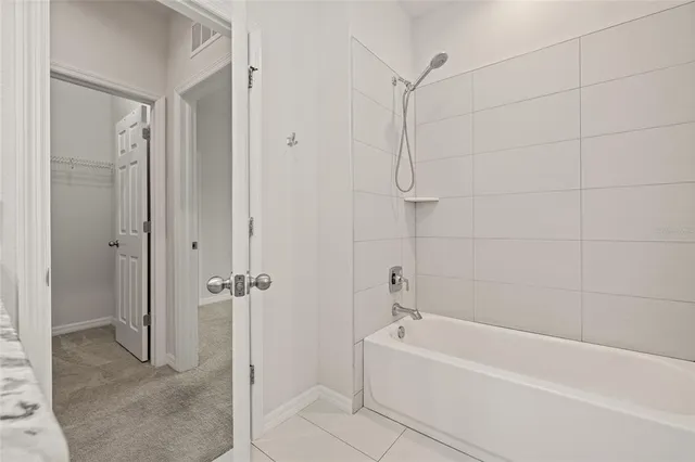 a bathroom with a bathtub and shower