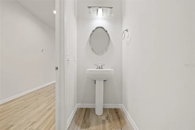 an empty room with a window and a ceiling fan