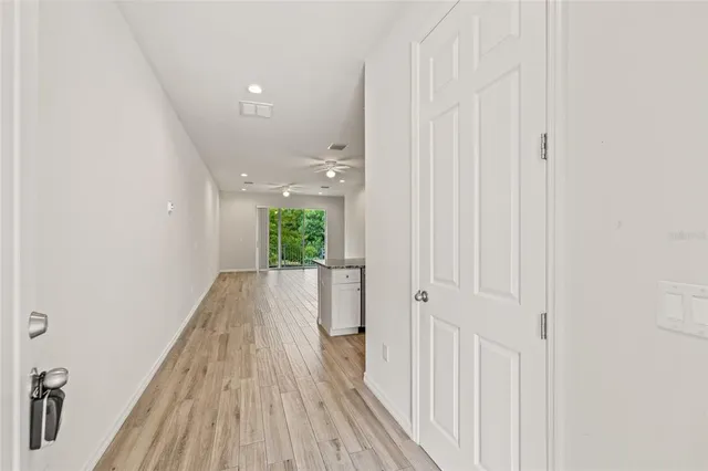 a view of a hallway with wooden floor