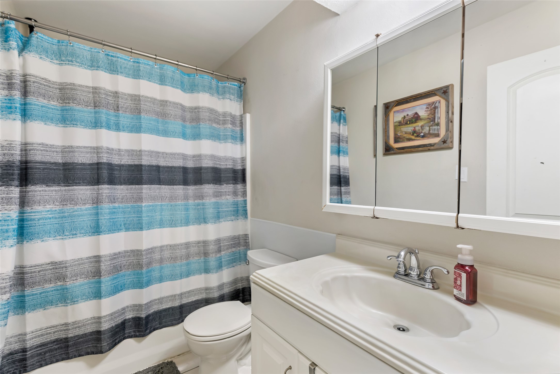 15816 Ramsey Road Crosby, TX 77532 - Photo 23 of 24 a bathroom with a sink a toilet a shower and a mirror