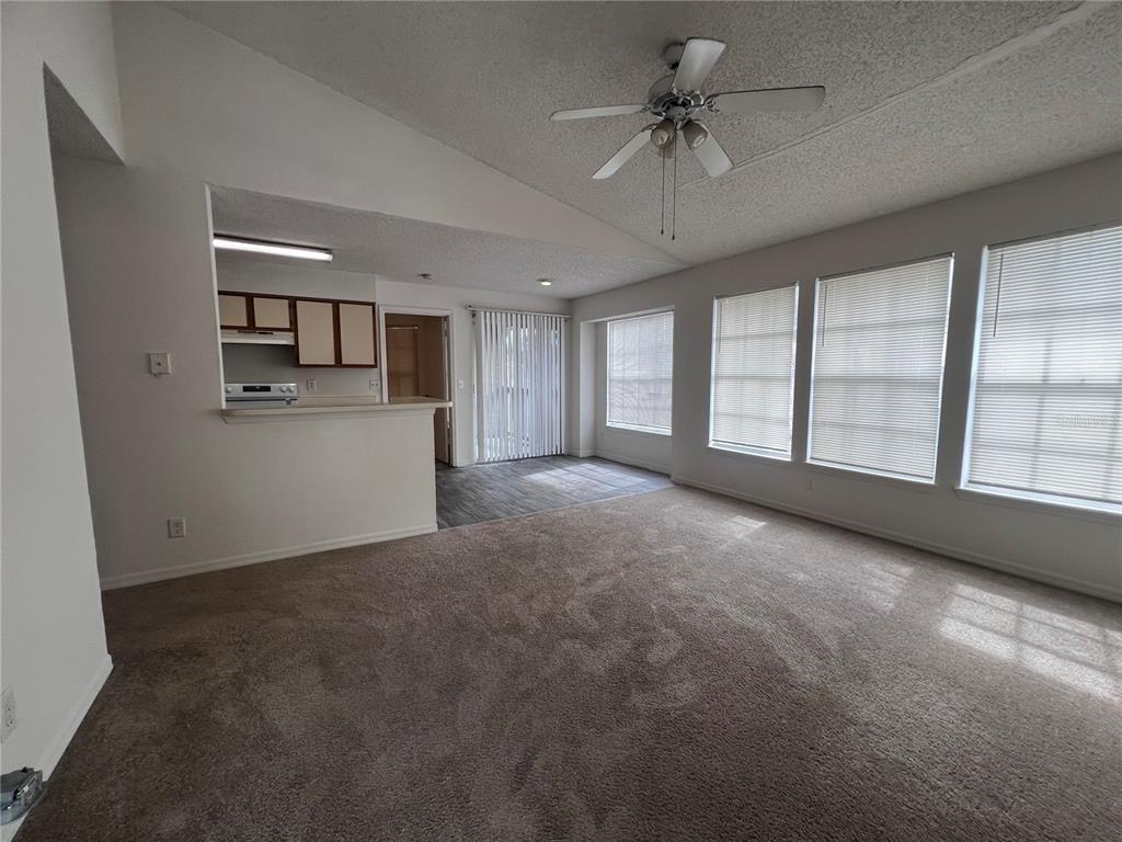 1061 South Hiawassee Road, Unit 1724 Orlando, FL 32835 - Photo 3 of 10 a view of a livingroom with a ceiling fan and window
