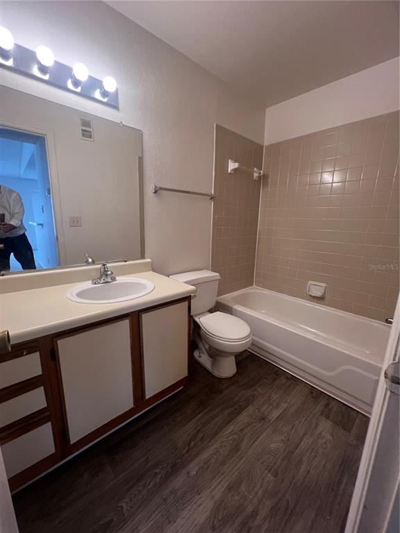 1061 South Hiawassee Road, Unit 1724 Orlando, FL 32835 - Photo 5 of 10 a spacious bathroom with a double vanity sink a toilet and a large mirror
