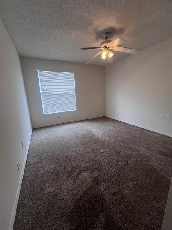 1061 South Hiawassee Road, Unit 1724 Orlando, FL 32835 - Photo 6 of 10 a view of a livingroom with a ceiling fan and window