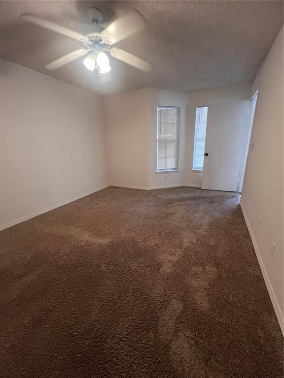 1061 South Hiawassee Road, Unit 1724 Orlando, FL 32835 - Photo 7 of 10 an empty room with windows and fan