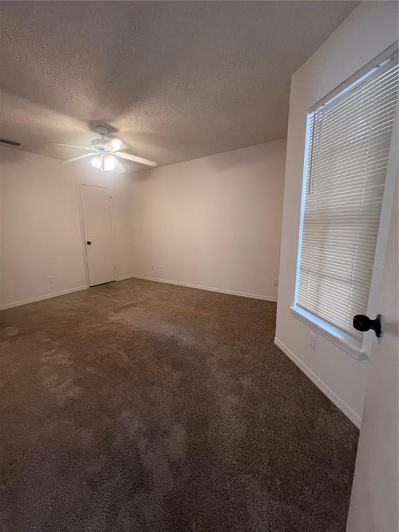 1061 South Hiawassee Road, Unit 1724 Orlando, FL 32835 - Photo 9 of 10 an empty room with windows and fan