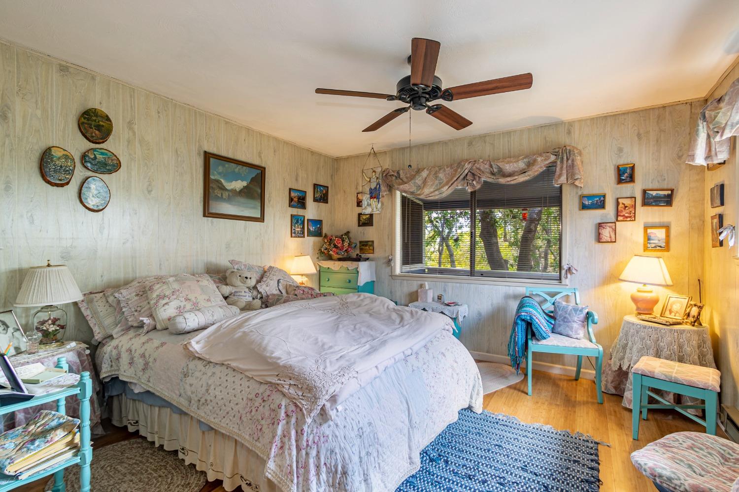 5090 Tiptop Road Mariposa, CA 95338 - Photo 15 of 46 a bedroom with a bed and wooden floor