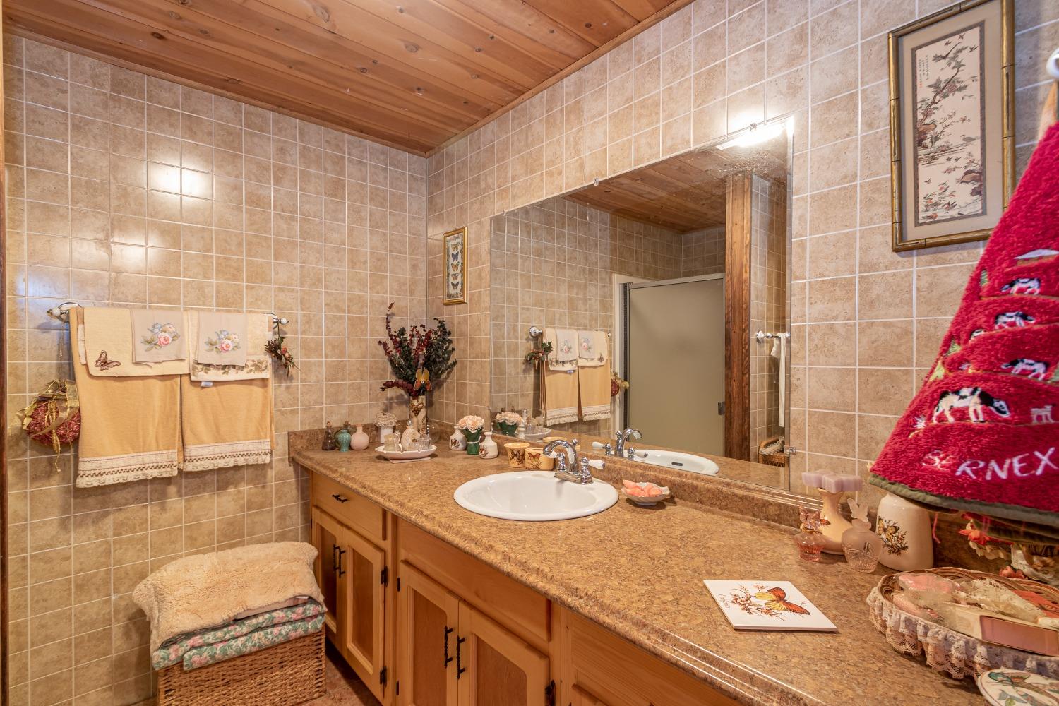 5090 Tiptop Road Mariposa, CA 95338 - Photo 20 of 46 a bathroom with a sink double vanity and a mirror
