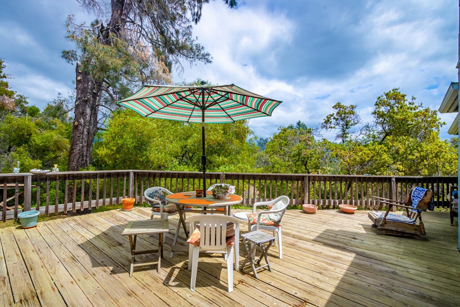 5090 Tiptop Road Mariposa, CA 95338 - Photo 2 of 46 a view of a balcony with furniture and wooden floor