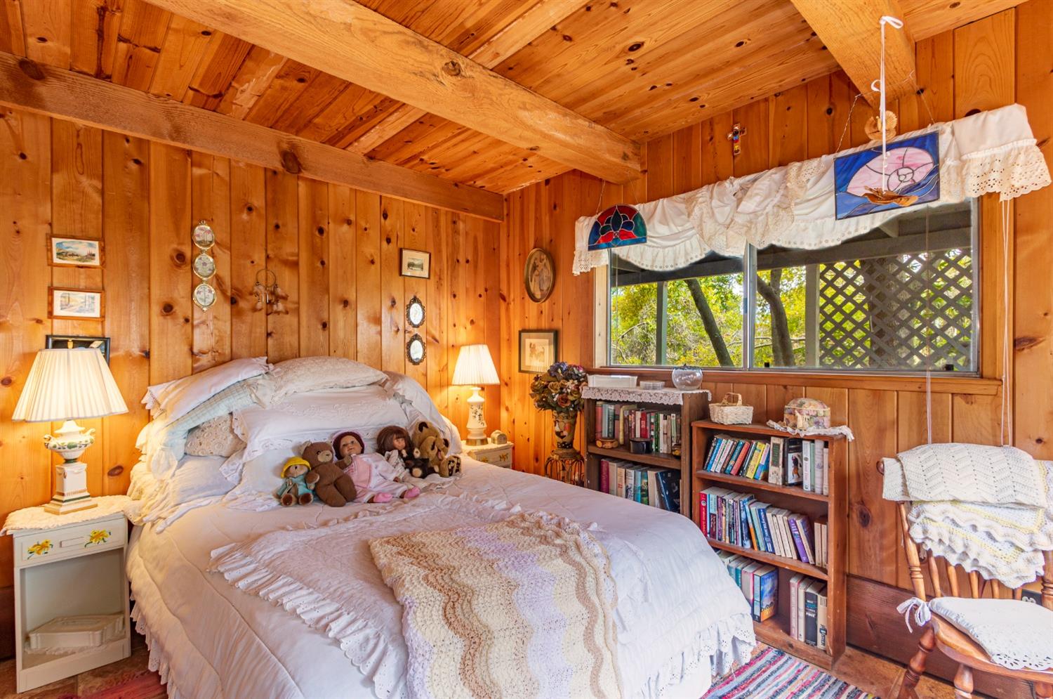 5090 Tiptop Road Mariposa, CA 95338 - Photo 22 of 46 a bedroom with a bed and a book shelf