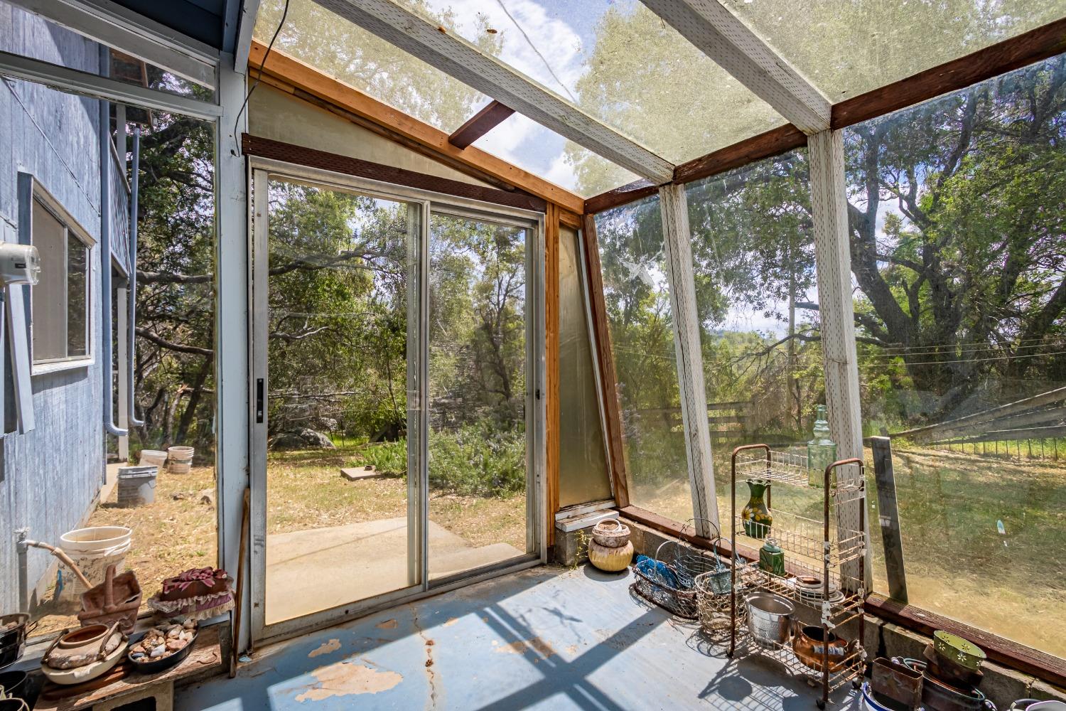 5090 Tiptop Road Mariposa, CA 95338 - Photo 23 of 46 a view of a porch with furniture and floor to ceiling window