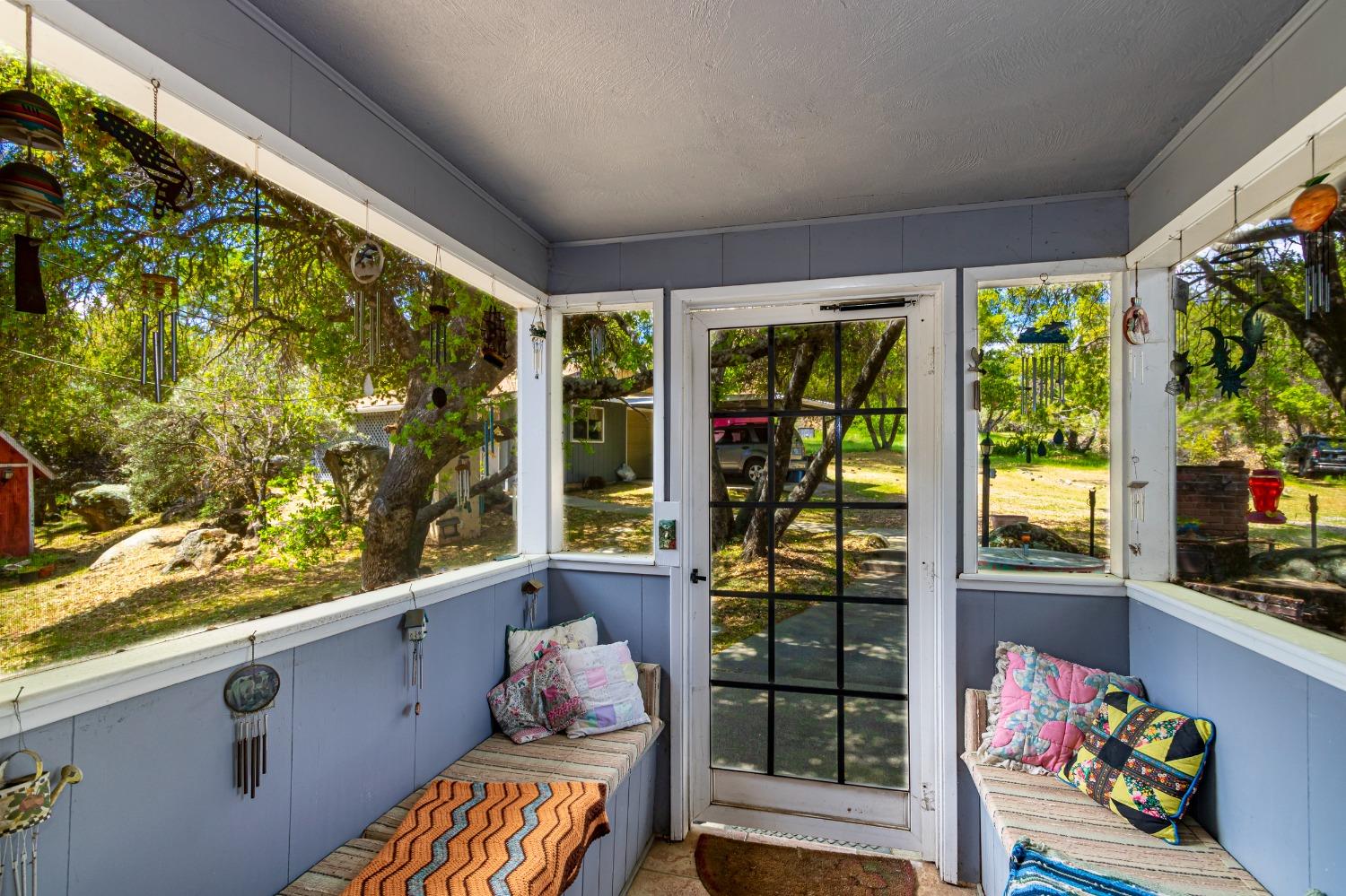 5090 Tiptop Road Mariposa, CA 95338 - Photo 7 of 46 a room with large windows and stairs