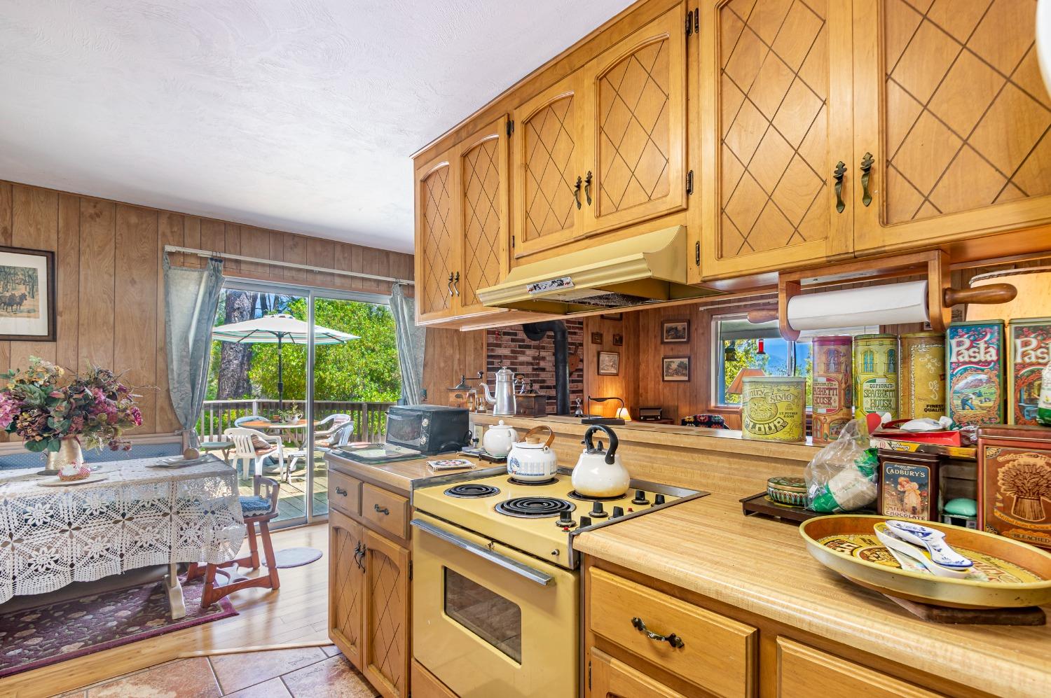 5090 Tiptop Road Mariposa, CA 95338 - Photo 8 of 46 a kitchen with stainless steel appliances granite countertop a stove and cabinets