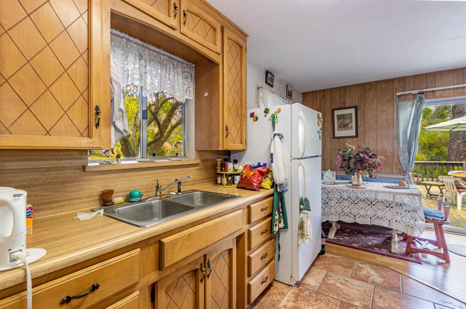 5090 Tiptop Road Mariposa, CA 95338 - Photo 9 of 46 a kitchen with stainless steel appliances a sink a refrigerator and a stove