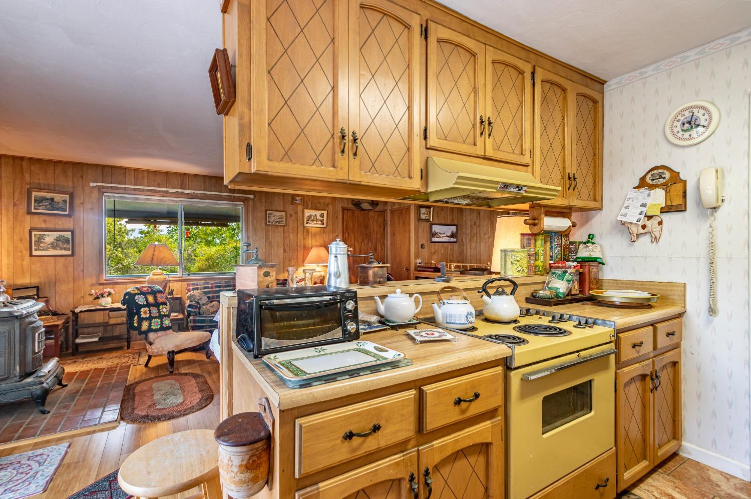 5090 Tiptop Road Mariposa, CA 95338 - Photo 10 of 46 a kitchen with stainless steel appliances granite countertop a stove and a dining table