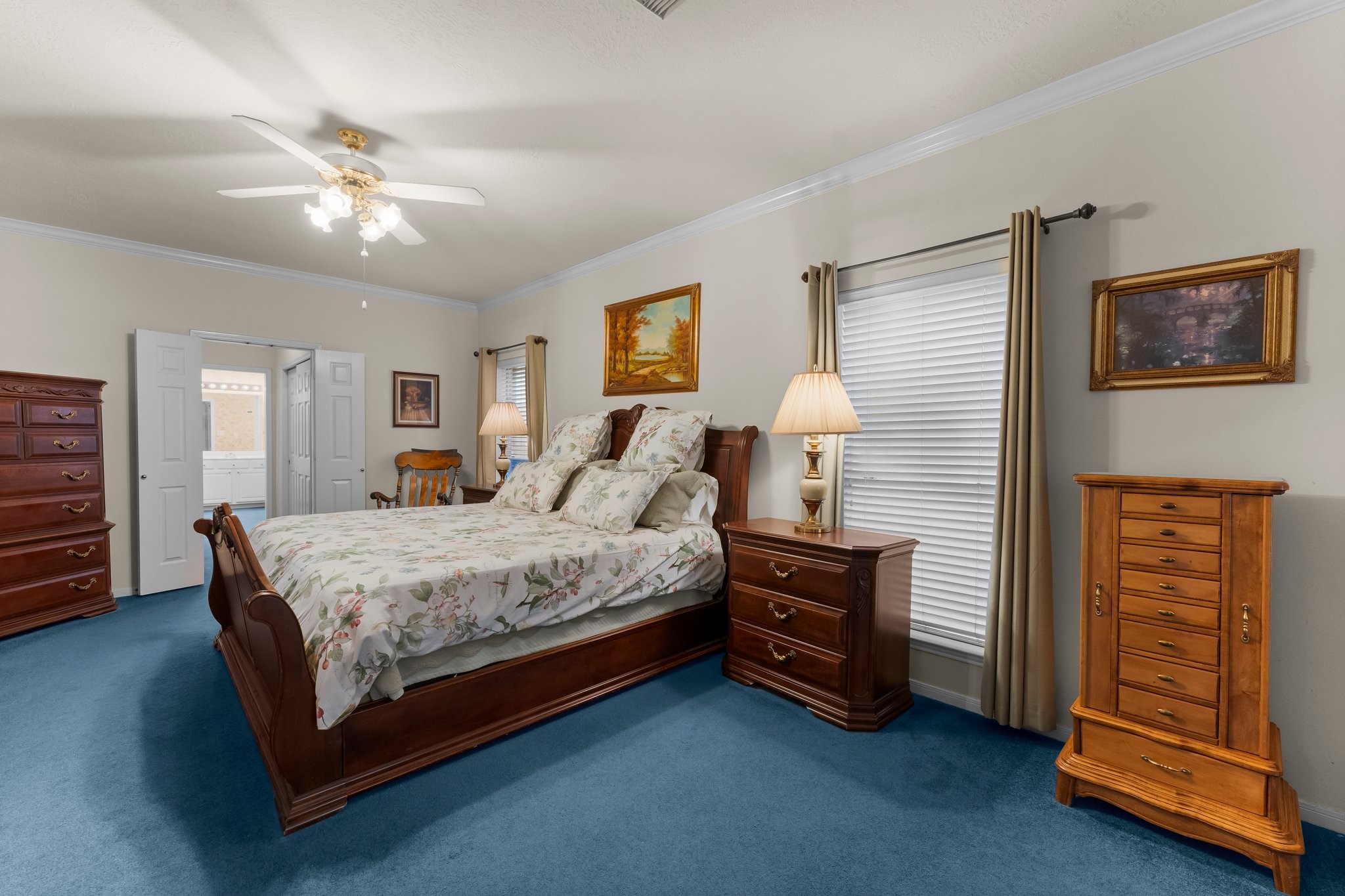 4210 Rainfall Drive Pasadena, TX 77505 - Photo 23 of 46 a spacious bedroom with a bed and a chandelier