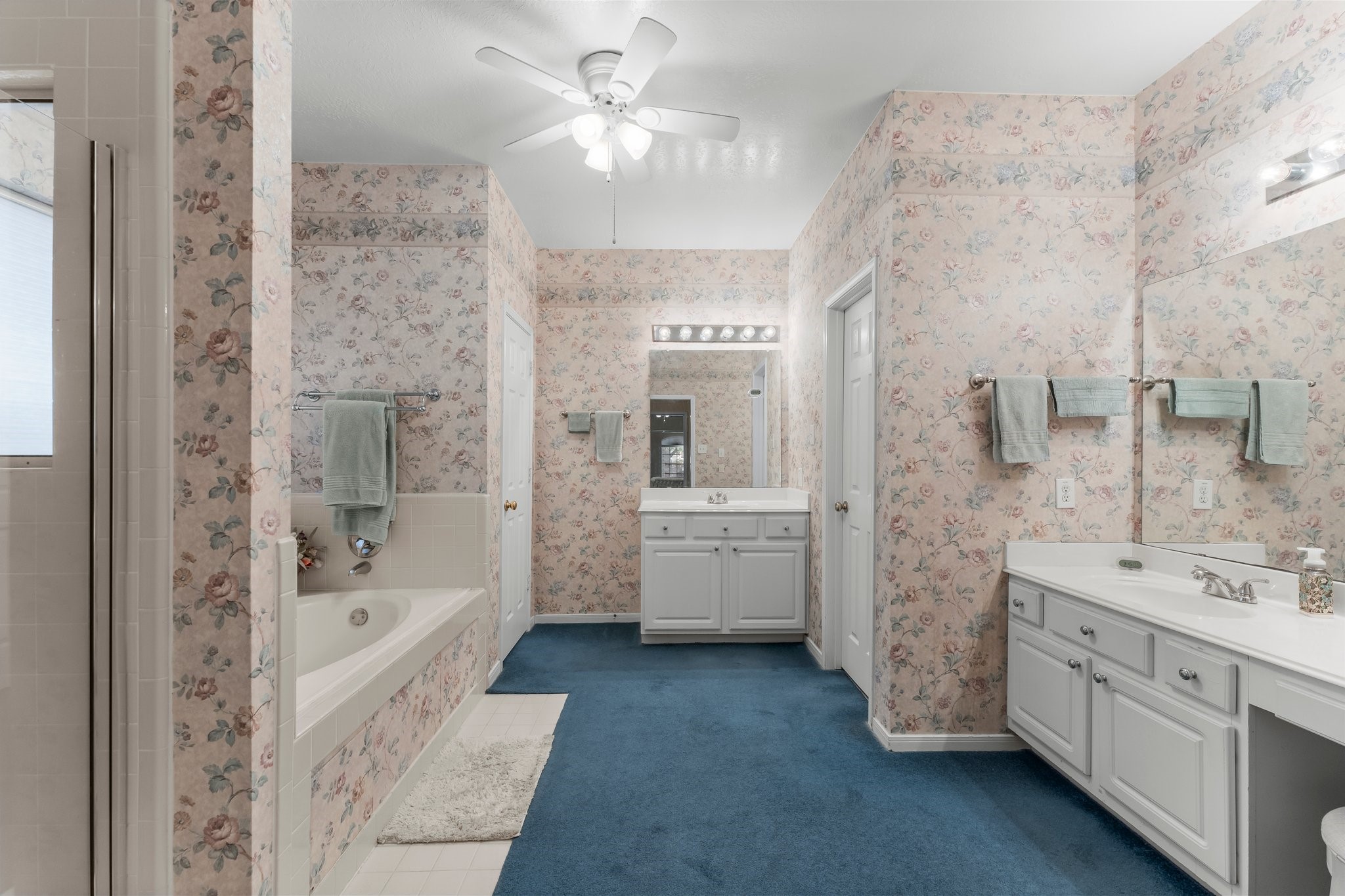 4210 Rainfall Drive Pasadena, TX 77505 - Photo 29 of 46 a bathroom with a double vanity sink a mirror a bathtub and a shower