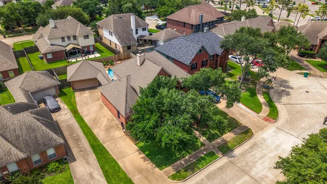a view of swimming pool with seating area and trees in the background