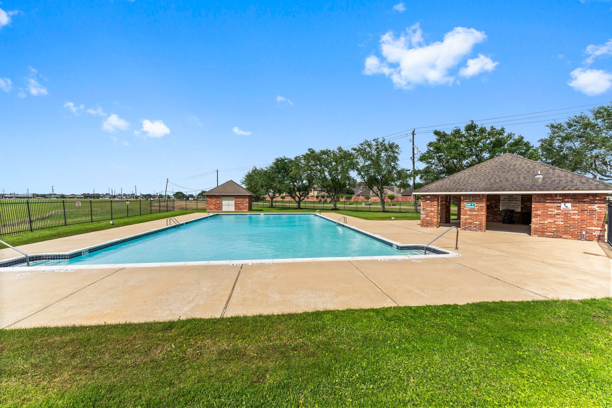 4210 Rainfall Drive Pasadena, TX 77505 - Photo 43 of 46 a view of swimming pool with seating area and trees in the background
