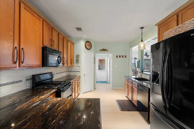 a kitchen with stainless steel appliances a refrigerator and a stove top oven