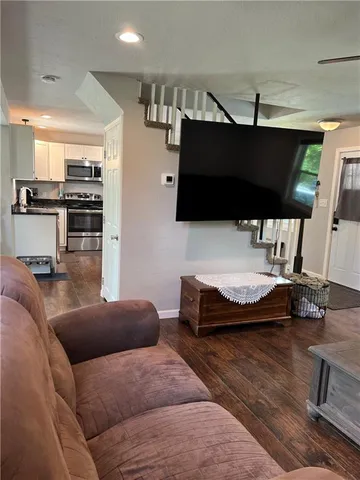 a bed room with a bed and a lamp on dresser