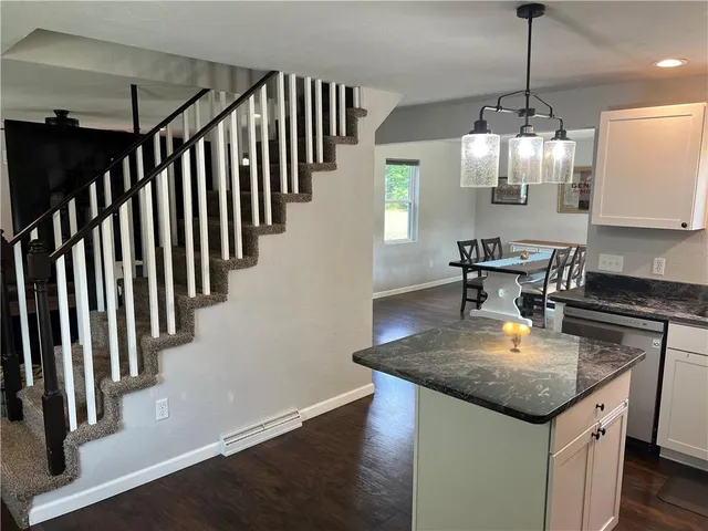 a kitchen with stainless steel appliances granite countertop microwave stove top oven and cabinets
